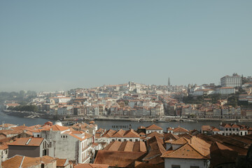 the view of old city with water and mountains on both sides