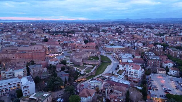 High drone footage of the cityscape of Rimini City at sunset in Emilia-Romagna region, Italy