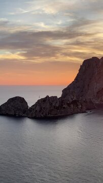 Vertical view of the sunset scene over the rocky island of Es Vedra off the island of Ibiza, Spain
