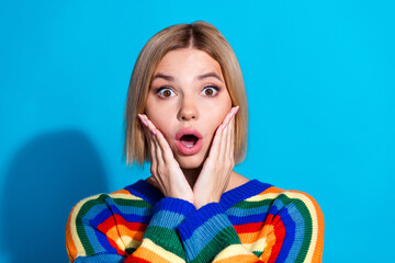 Portrait of pretty young girl staring wear striped pullover isolated on blue color background