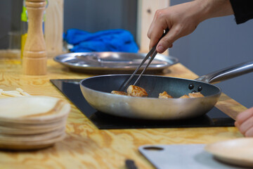 professional chef cooking in a frying pan.