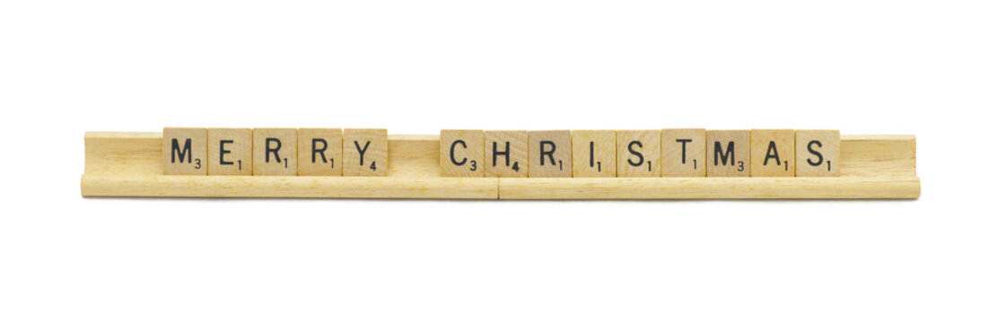Miami, Florida 5-1-2024 Merry Christmas made with square wooden tile English alphabet letters with natural color and grain on a wood rack holder isolated on white background
