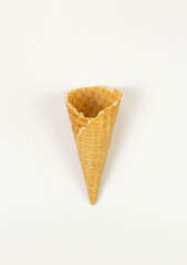 Top view of ice cream waffle cone on white background. Summer wallpaper, flat lay, copy space.