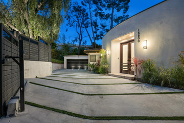 Picturesque backyard featuring a stone walkway and steps leading to a front entrance