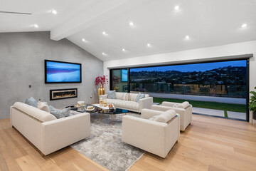 Contemporary living room showcases two stylish sofas and two end tables next to a large window