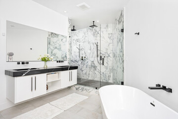 Modern white bathroom with a luxurious marble countertop and a bathtub
