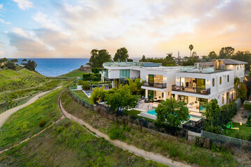 View of beachfront property, illuminated by the setting sun