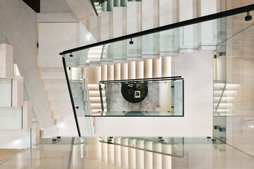 Contemporary interior featuring a grand staircase with a clock adorning the centre