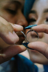 Wedding rings held by a loving couple, symbolizing their commitment and unity