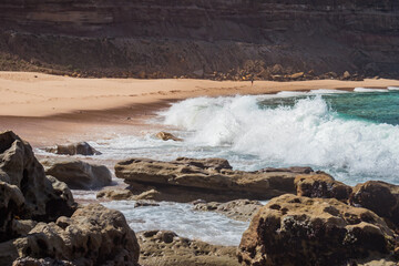 Landscape on Calada beach with wave breaking on rocks and sand, Ericeira PORTUGAL