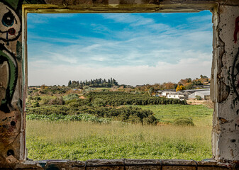 Picturesque view through a window showcasing a scenic countryside landscape