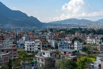 Several homes in urban area and mountains in background during day time
