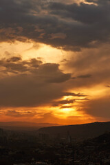 Scenic view of Tbilisi surrounded by majestic mountains in the distance at sunrise in Georgia