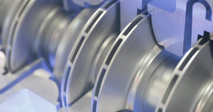 Internal structure of a centrifugal pump. Close-up handheld shot, real time motion, artificial indoors light. Abstract industrial background.