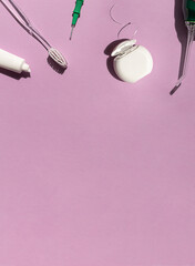 Dental care concept composition with toothbrush, tooth floss and toothpaste on the bright violet background. Copy space