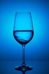 a blue and clear glass of water on top of a table