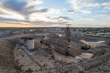 Disused abandoned mine shaft and buildings at Broken Hill's Line of Lode underground mine site at sunset - NSW, Australia