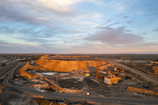 Disused abandoned mine shaft and buildings at Broken Hill's Line of Lode underground mine site at sunset - NSW, Australia