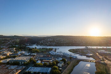 Aerial photo looking out over Launceston above the North Esk River at sunset with blue sky