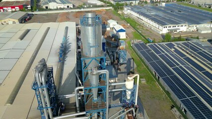 Aerial flight over factories in cloudy weather