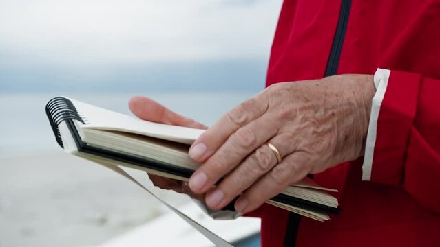 Man Turning Pages Of The Block Notes 