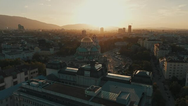 Drone footage of St. Alexander Nevsky Cathedral and the cityscape of Sofia at sunset, Bulgaria