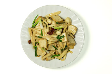 Stir-fried tofu with white crab mushroom, spring onion and red dried chili pepper (Asian vegan food) in white plate isolated on white background with clipping path, top view, flat lay.