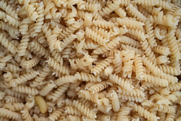 Top view of raw macaroni noodles in a stack