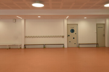 empty school hall with closed door indicating class and sanitary door