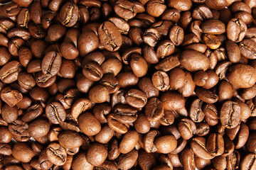 brown coffee beans sitting on top of each other on a table