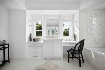 this is an empty white bathroom with a chair and vanity