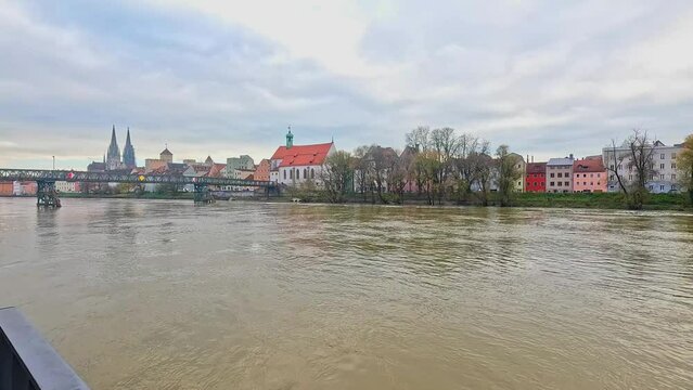 Iron Bridge (Eiserner Steg) and the buildings on the Danube river at sunset in Regensburg, Germany