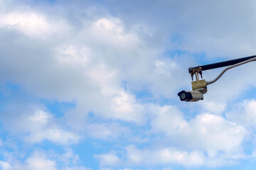Closed circuit camera or CCTV camera outdoor with blue sky for security in the park.