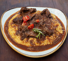 Dish of polenta and meat.