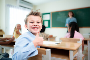 Fototapeta premium Teacher and students, Learn and study in a classroom of school where youngsters sit and listen attentively.