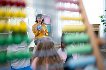 Teacher and students, Learn and study about airplanes in a classroom of school where youngsters sit and listen attentively.