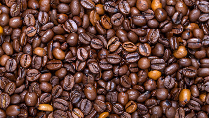 Fototapeta premium Roasted coffee beans background. Top view. Coffee background for coffee business cafe coffee shop