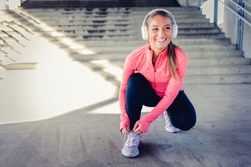 Fitness, sports and woman with shoes ready to start running outdoors for exercise, raining and...