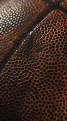 Textured surface of a leather basketball with a mottled brown and black color scheme. Sporting goods concept.