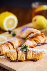 Sweet pastries, puff pastries with pears, on a wooden table