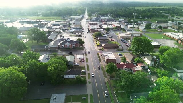 Flyover Gentry Avenue in Checotah city, McIntosh County, Oklahoma early foggy morning, nestled intersection of interstate I-40, US highway 69, small town with red brick buildings, antique malls. USA