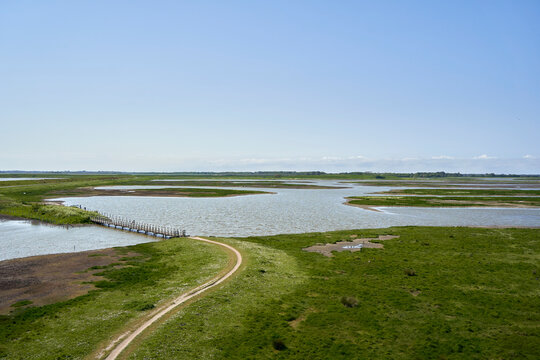 National Park in Holland. Landscape in spring on a sunny day. Path over sea. Netherlands, Zeeland, Oosterschelde.