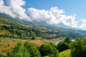 Obraz premium Symphonic Serenity: Green Mountains Compose a Melody with Blue Skies