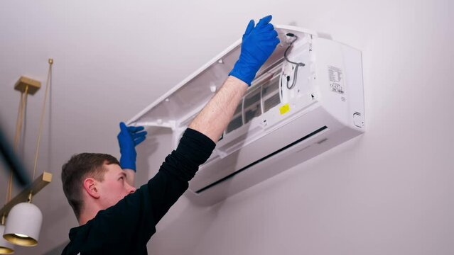 close up in the apartment the cleaner is cleaning the filters in air conditioner filling the cooler