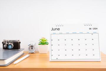 Desktop Calendar for June 2024 year and vintage camera with diary for Planner to plan