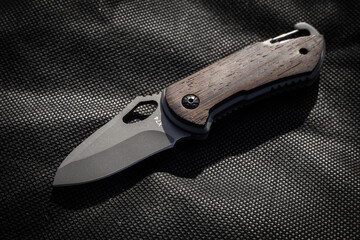 Tactical knife on a fiber background