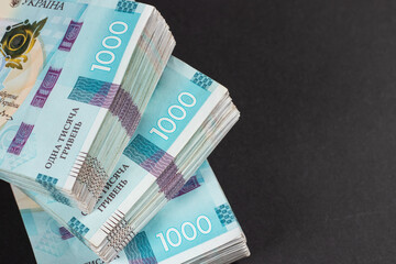 a pack of hryvnias on the table. Financial concept. Ukrainian money. 1000 hryvnia on dark background.