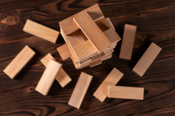 tower made of wooden blocks on wooden background, space for text