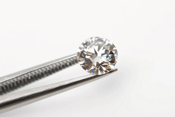 brilliant cut diamond tweezers on white background