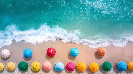 Aerial view of colorful umbrellas on beach, turquoise sea, white waves, sunny day